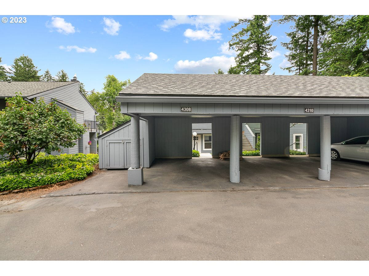 4308 Southwest Dickinson Street, Unit 15 Portland, OR 97219 - Photo 28 of 35 a view of a house with porch and parking