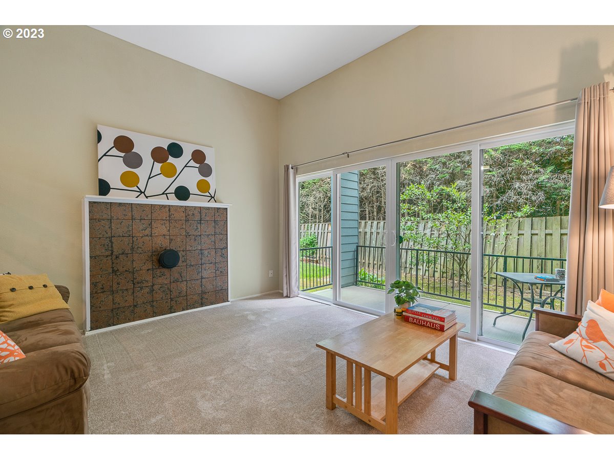 4308 Southwest Dickinson Street, Unit 15 Portland, OR 97219 - Photo 3 of 35 a living room with furniture and a floor to ceiling window