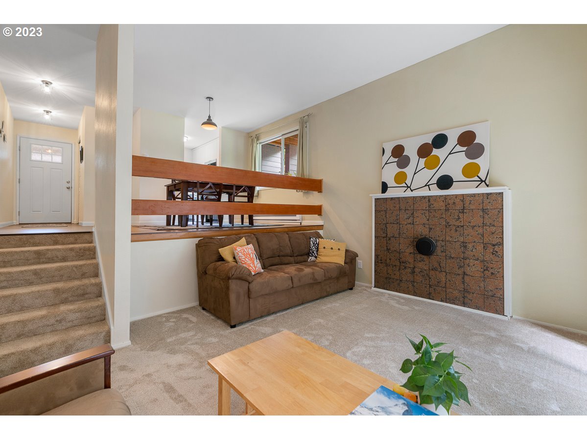 4308 Southwest Dickinson Street, Unit 15 Portland, OR 97219 - Photo 4 of 35 a living room with furniture and a fireplace