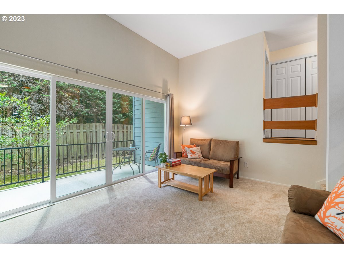 4308 Southwest Dickinson Street, Unit 15 Portland, OR 97219 - Photo 6 of 35 a living room with furniture and floor to ceiling windows