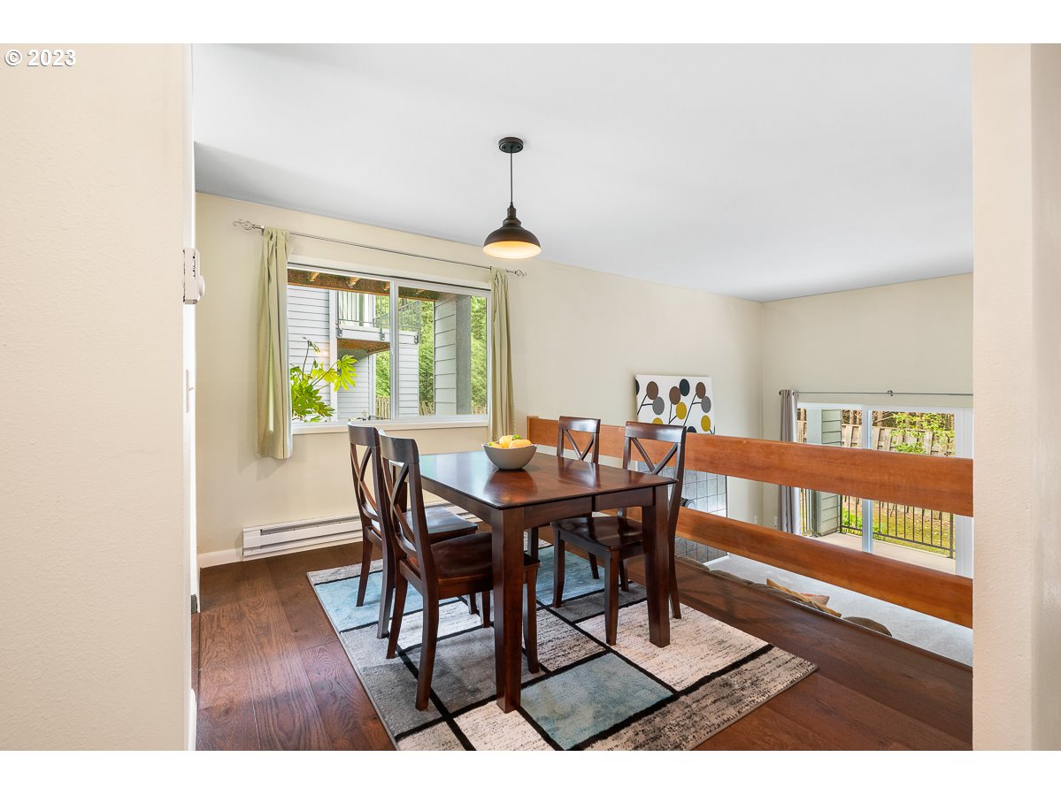 4308 Southwest Dickinson Street, Unit 15 Portland, OR 97219 - Photo 8 of 35 a dining room with furniture window and wooden floor