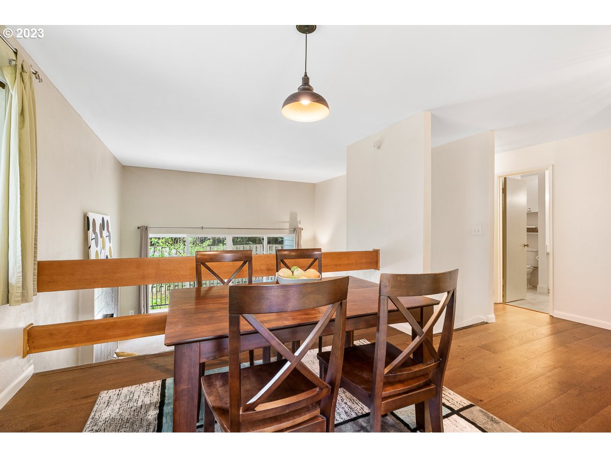 4308 Southwest Dickinson Street, Unit 15 Portland, OR 97219 - Photo 9 of 35 a view of a dining room with furniture and wooden floor
