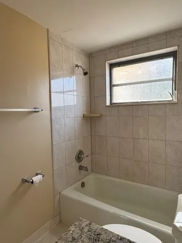 a bath room with a bath tub and a shower