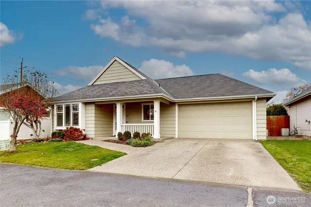 a front view of a house with a yard and trees