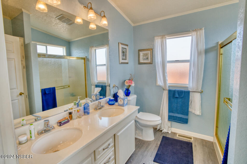 919 Vista Del Rio Santa Maria, CA 93458 - Photo 12 of 29 a bathroom with a sink vanity mirror and toilet