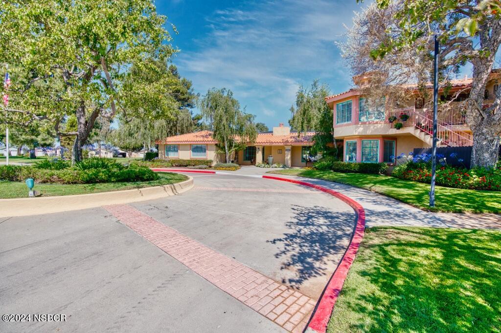 919 Vista Del Rio Santa Maria, CA 93458 - Photo 21 of 29 a front view of a building with garden and trees