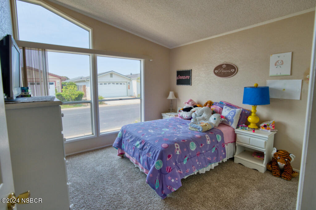 919 Vista Del Rio Santa Maria, CA 93458 - Photo 8 of 29 a bedroom with a bed and large windows