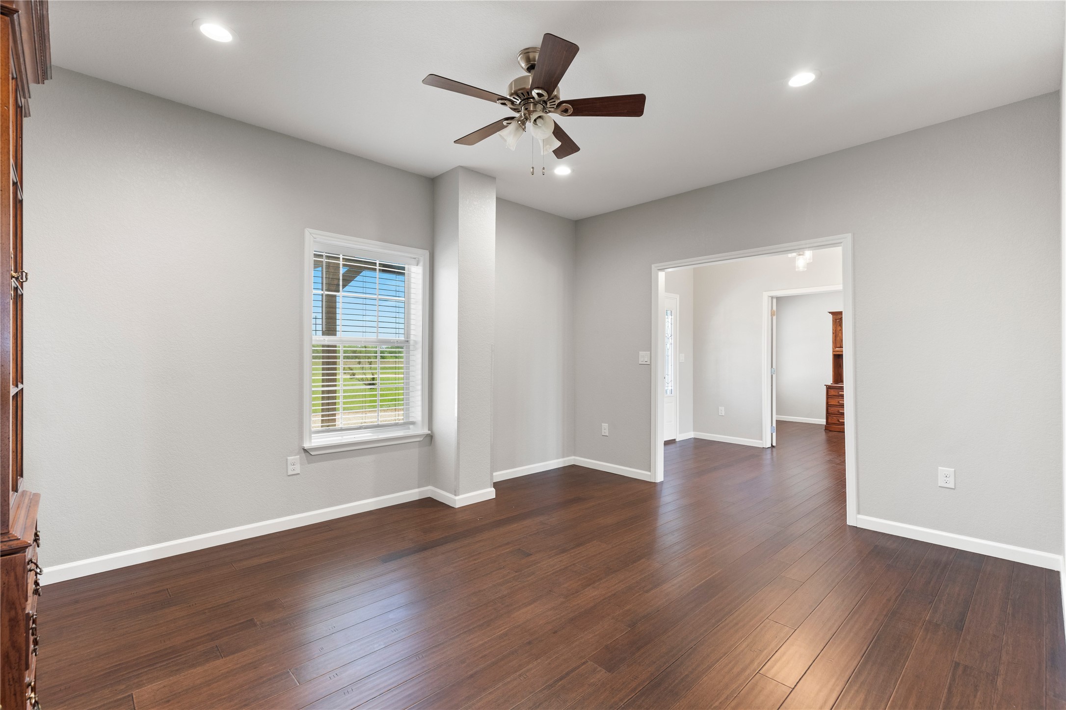 1293 Pioneer Road Seguin, TX 78155 - Photo 24 of 40 Rich hardwood flooring stretches across this naturally illuminated interior space, offering an inviting atmosphere.