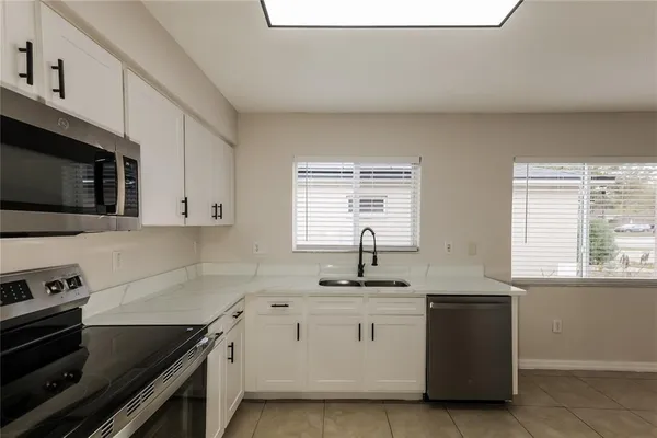 a kitchen with stainless steel appliances a sink stove and cabinets