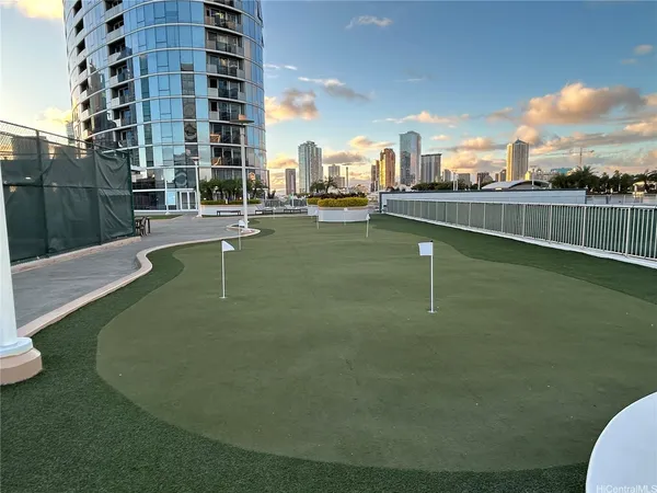 a swimming pool with outdoor seating and yard