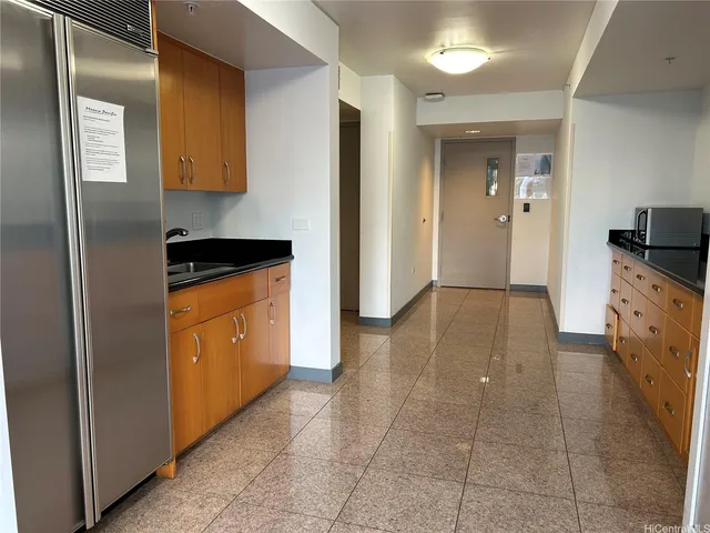 a kitchen with granite countertop a cabinets and steel appliances