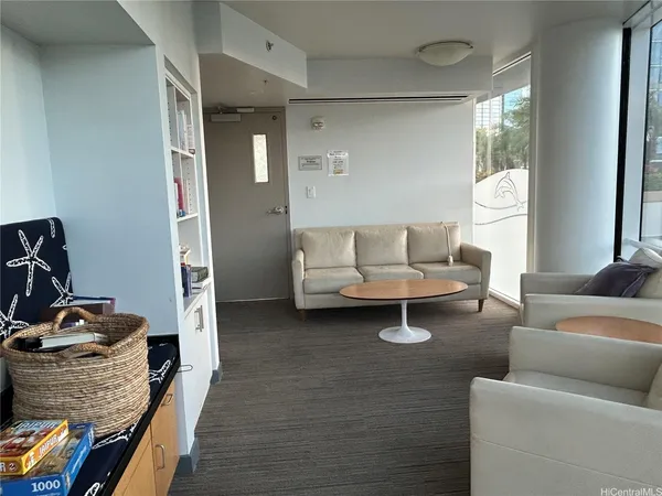 a living room with furniture and a dresser