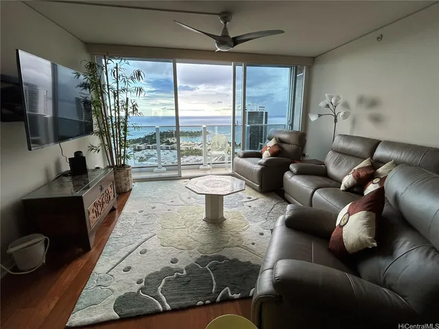 a living room with furniture and a floor to ceiling window