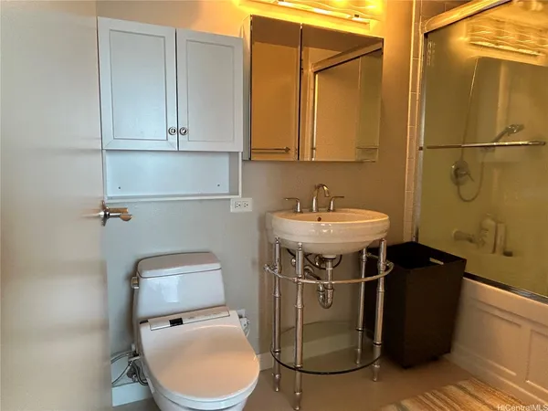 a bathroom with a sink toilet and shower