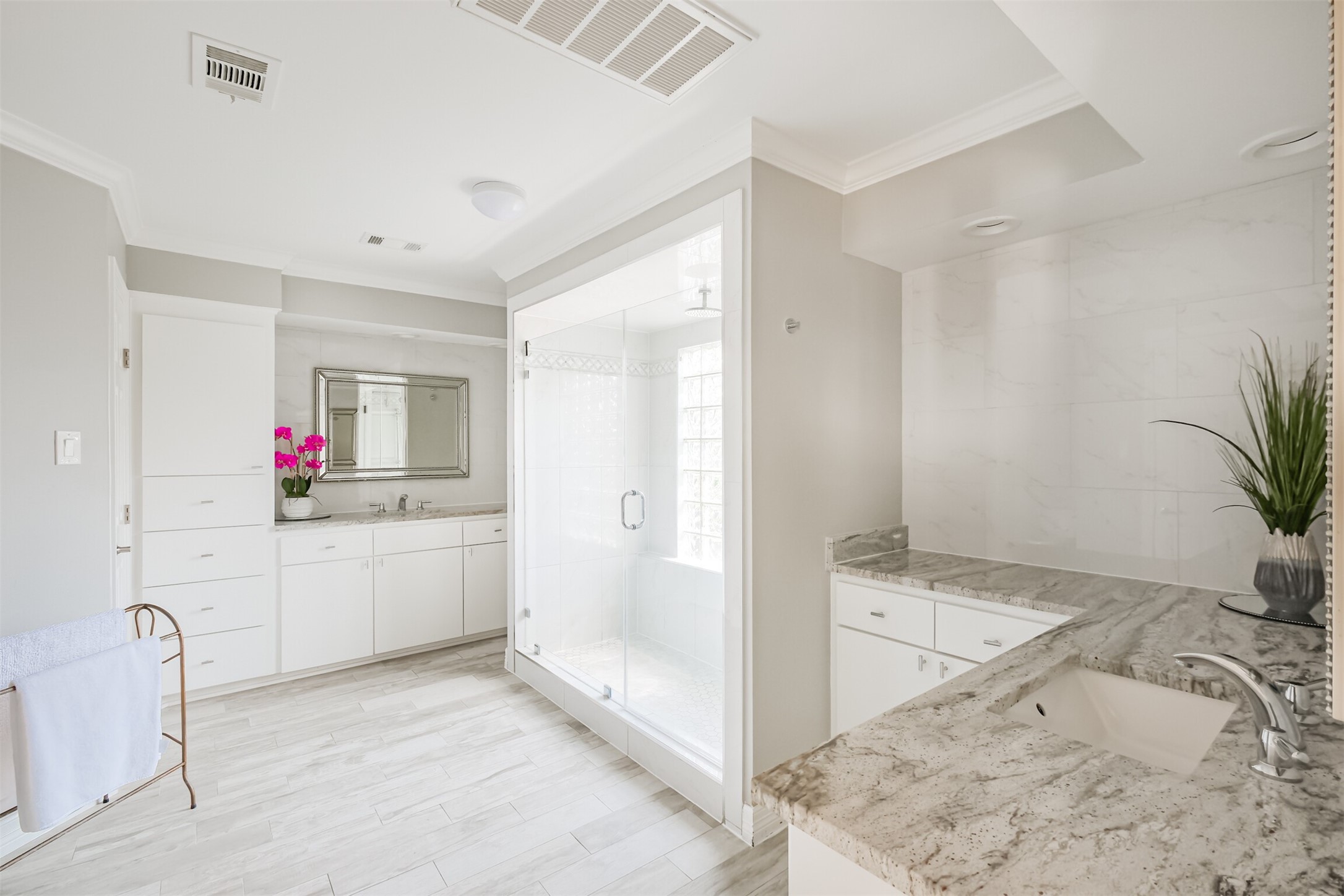 1007 Arrow Hill Road Houston, TX 77077 - Photo 25 of 48 The primary bathroom showcases tile wood floors, crown molding, granite counters, double sinks, dual vanities. two walk-in closets and plenty of cabinet space!