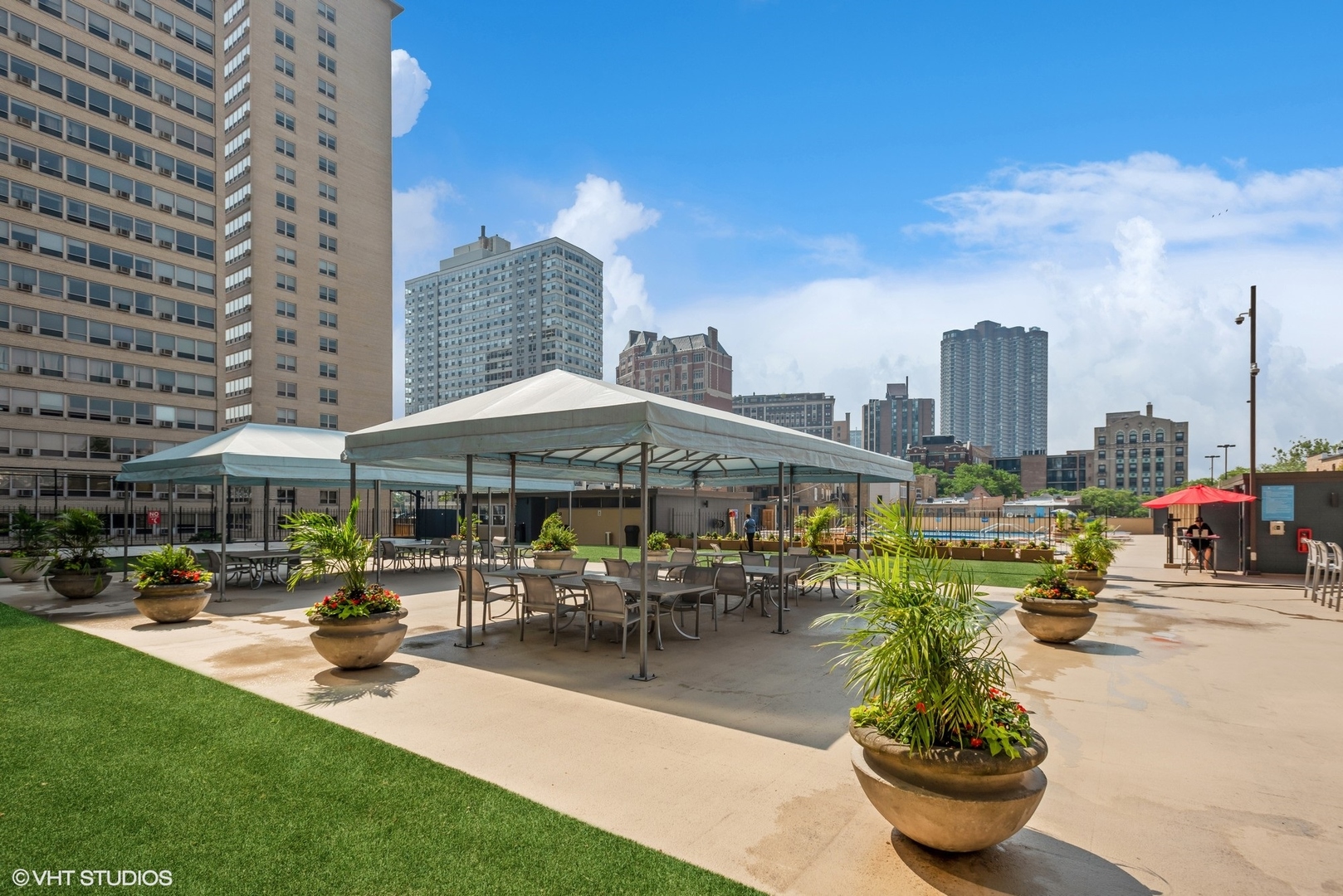 655 West Irving Park Road, Unit 5507 Chicago, IL 60613 - Photo 14 of 17 a patio with tables and chairs