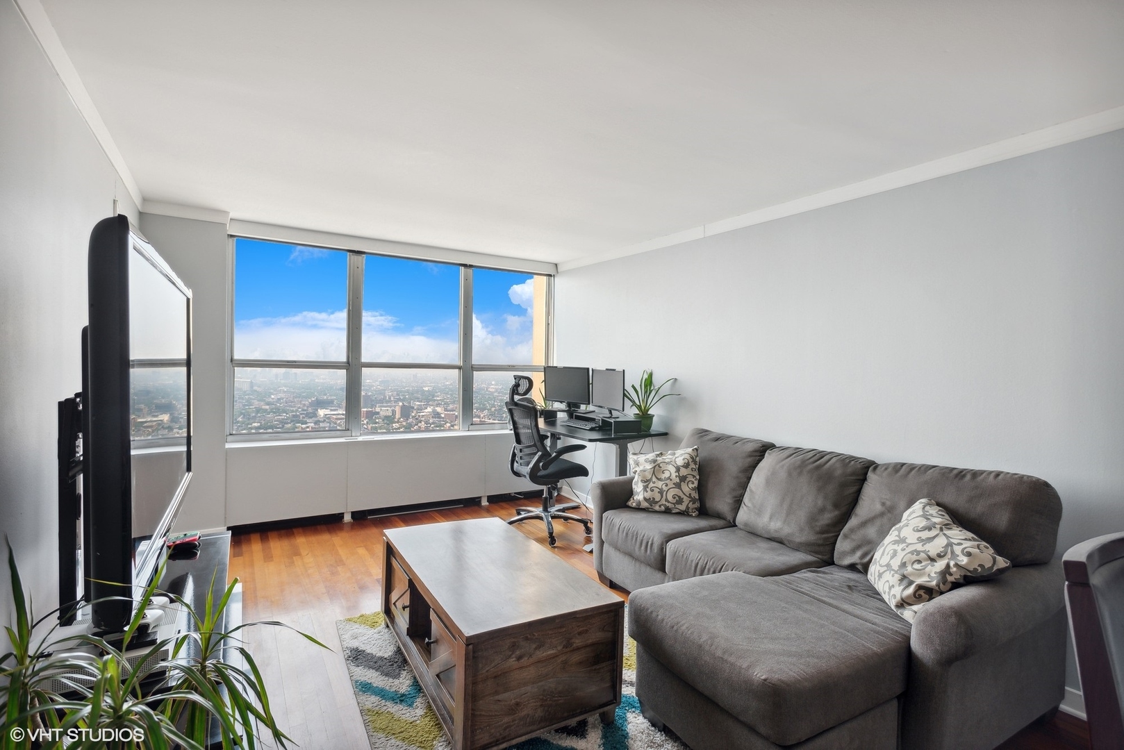 655 West Irving Park Road, Unit 5507 Chicago, IL 60613 - Photo 2 of 17 a living room with furniture and a large window