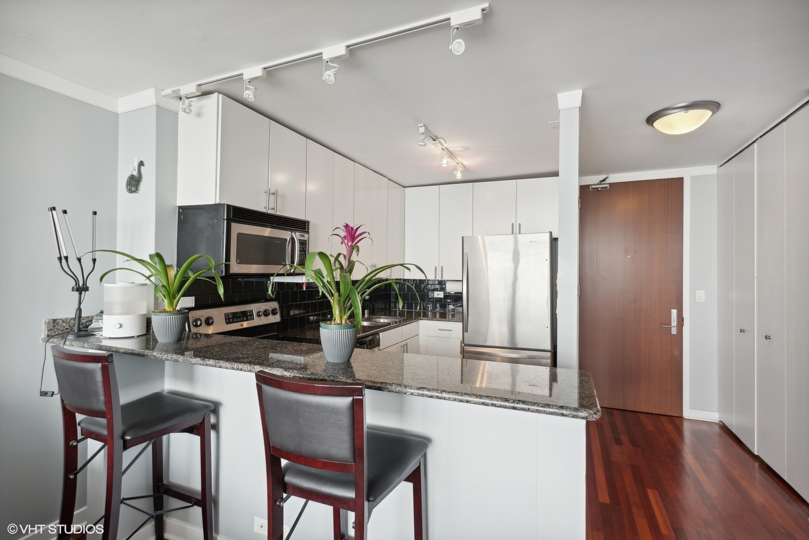 655 West Irving Park Road, Unit 5507 Chicago, IL 60613 - Photo 4 of 17 a kitchen with a refrigerator and microwave
