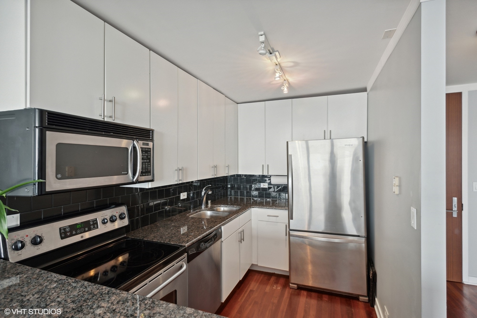 655 West Irving Park Road, Unit 5507 Chicago, IL 60613 - Photo 6 of 17 a kitchen with a refrigerator stove and microwave
