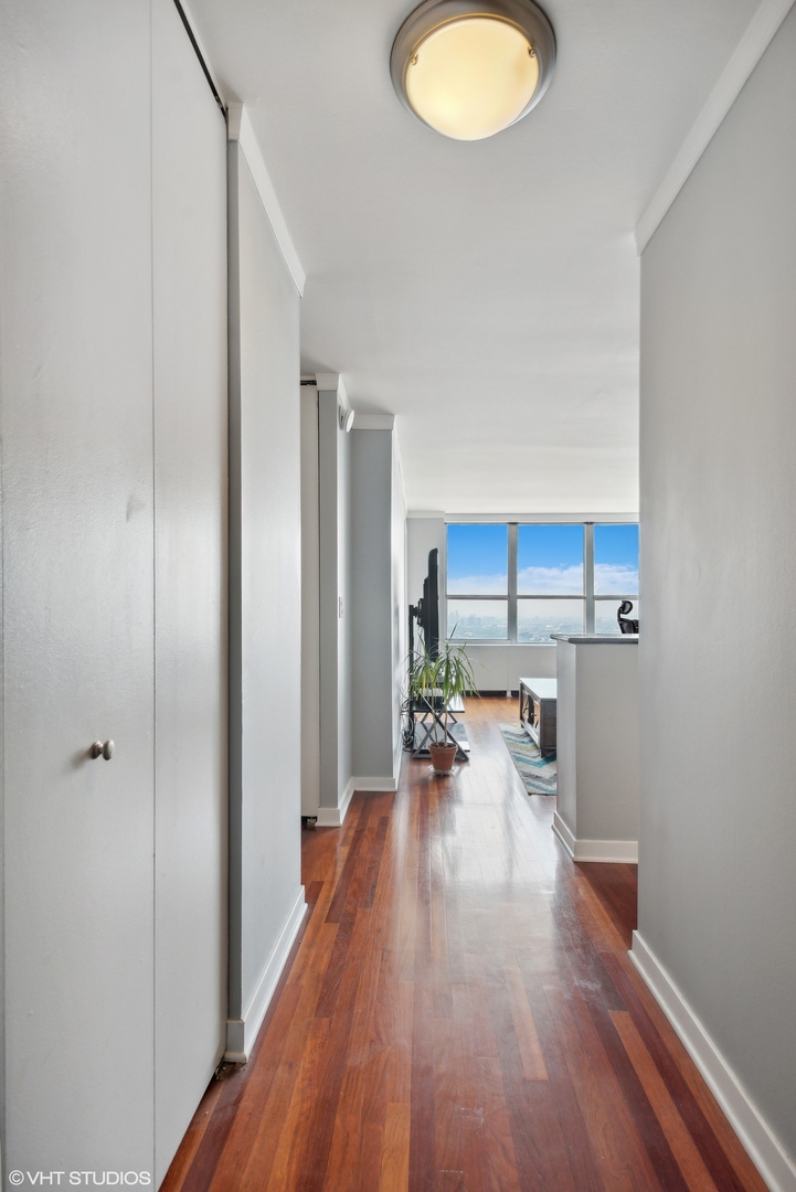 655 West Irving Park Road, Unit 5507 Chicago, IL 60613 - Photo 7 of 17 a view of a kitchen with a sink wooden floor and a window