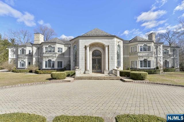 a view of a white house with a yard and large tree