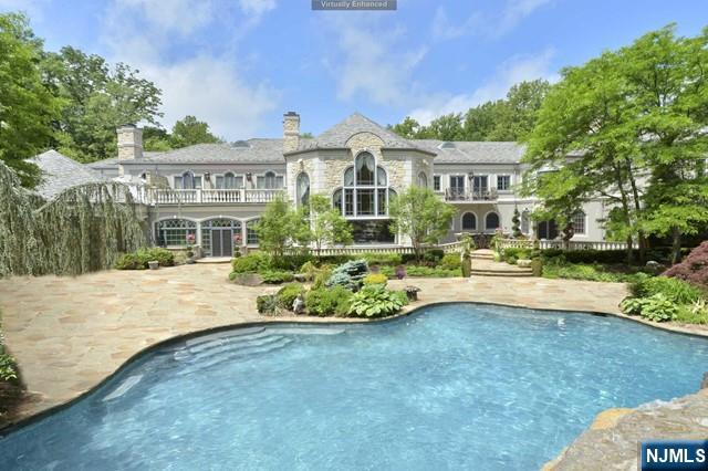 101 Fox Hedge Road Saddle River, NJ 07458 - Photo 2 of 21 a front view of a house with a yard table and chairs
