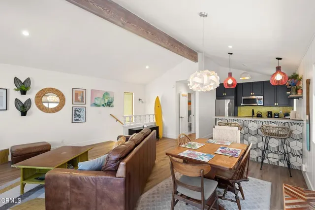 a kitchen with stainless steel appliances a sink a stove and cabinets