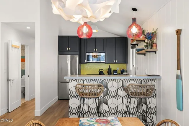 a kitchen with stainless steel appliances granite countertop a refrigerator and a stove top oven