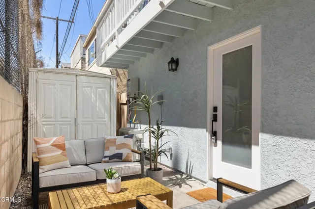 a kitchen with stainless steel appliances granite countertop grey cabinets a stove a sink and dishwasher with wooden floor