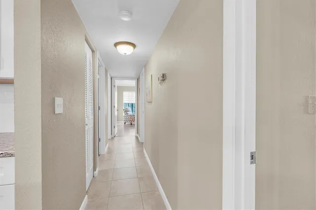 a spacious bedroom with a bed and glass window