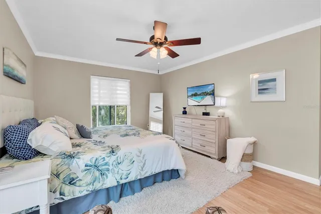 a bedroom with a large bed and a chandelier