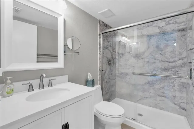 a view of walk in closet with clothes