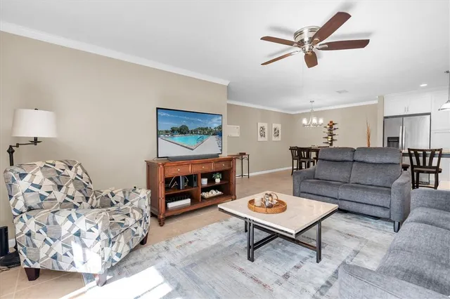 a kitchen with stainless steel appliances granite countertop a refrigerator a stove a sink a microwave and a refrigerator