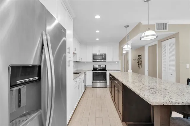 a kitchen with a sink stove and microwave