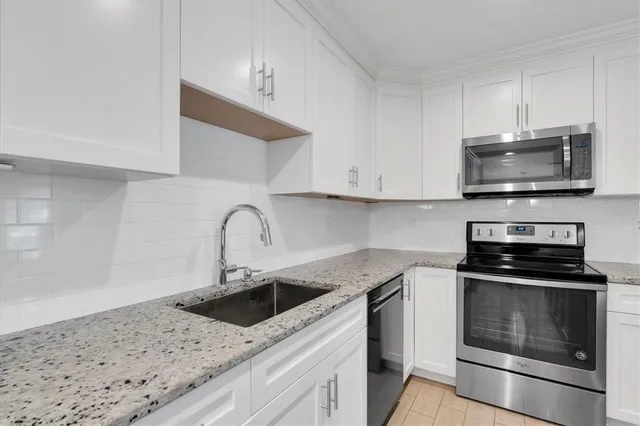 a large kitchen with a table and chairs