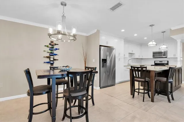a view of a dining room with furniture and chandelier