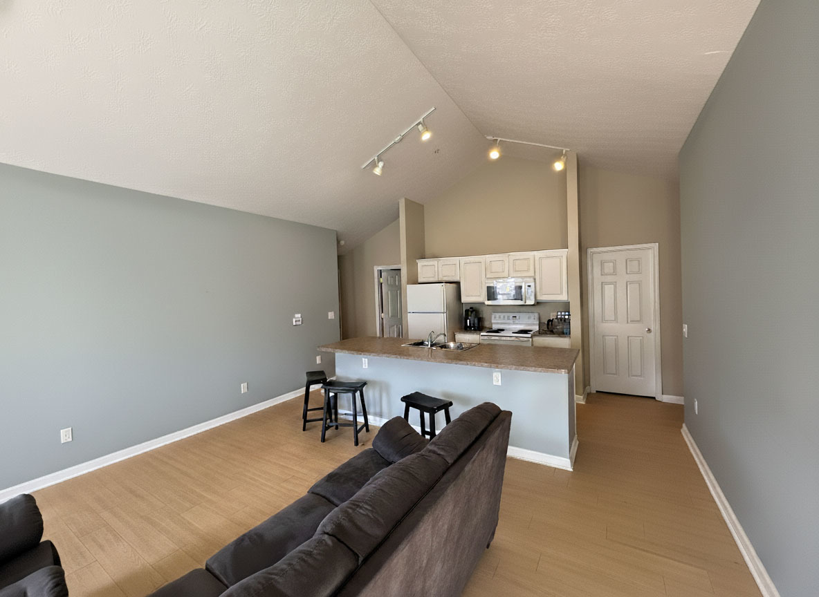 1905 North Lincoln Avenue, Unit 319 Urbana, IL 61801 - Photo 2 of 10 a living room with stainless steel appliances furniture a rug and a kitchen view