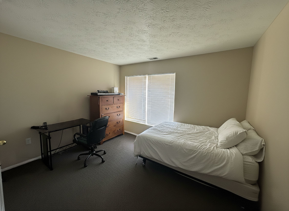 1905 North Lincoln Avenue, Unit 319 Urbana, IL 61801 - Photo 6 of 10 a bedroom with a bed and a table in it