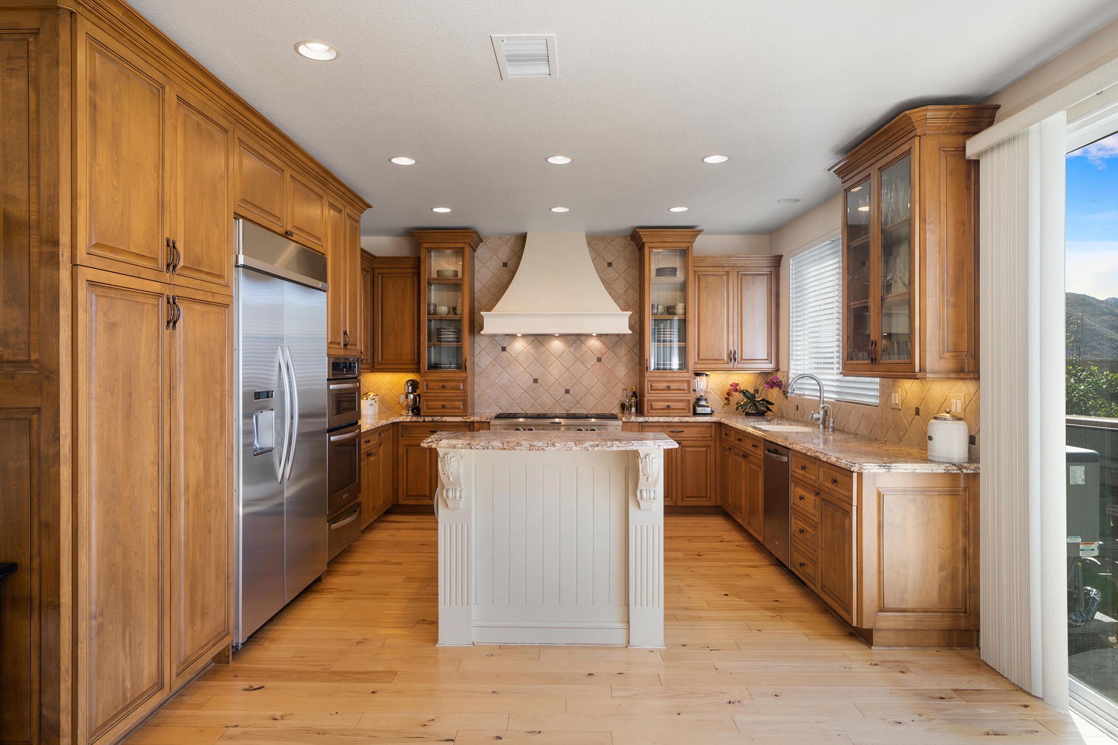 346 Woodland Road Simi Valley, CA 93065 - Photo 3 of 14 a kitchen with stainless steel appliances granite countertop a refrigerator a stove and a sink