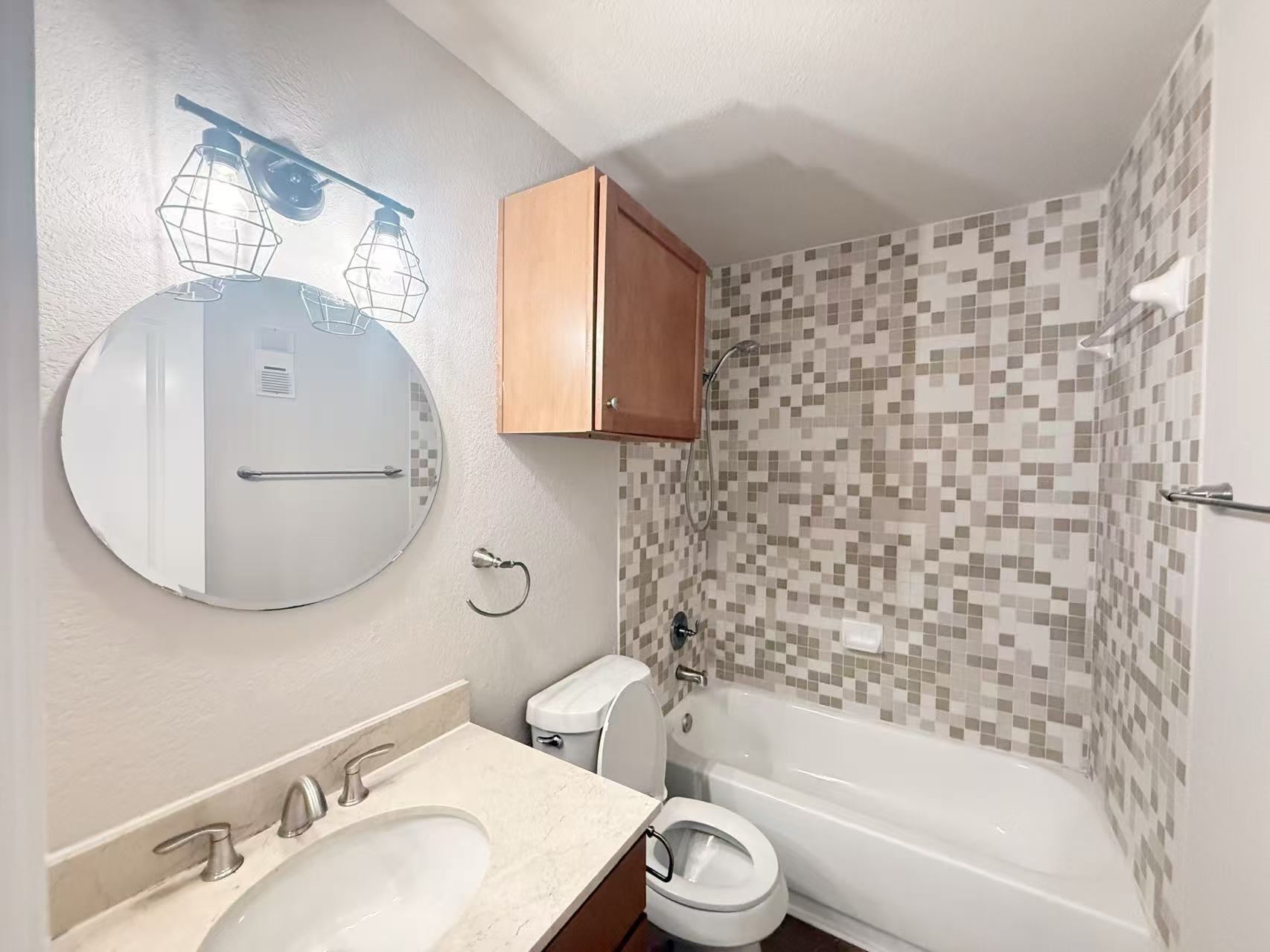 3204 Menchaca Road, Unit 601 Austin, TX 78704 - Photo 10 of 12 a bathroom with a bathtub sink vanity mirror and toilet