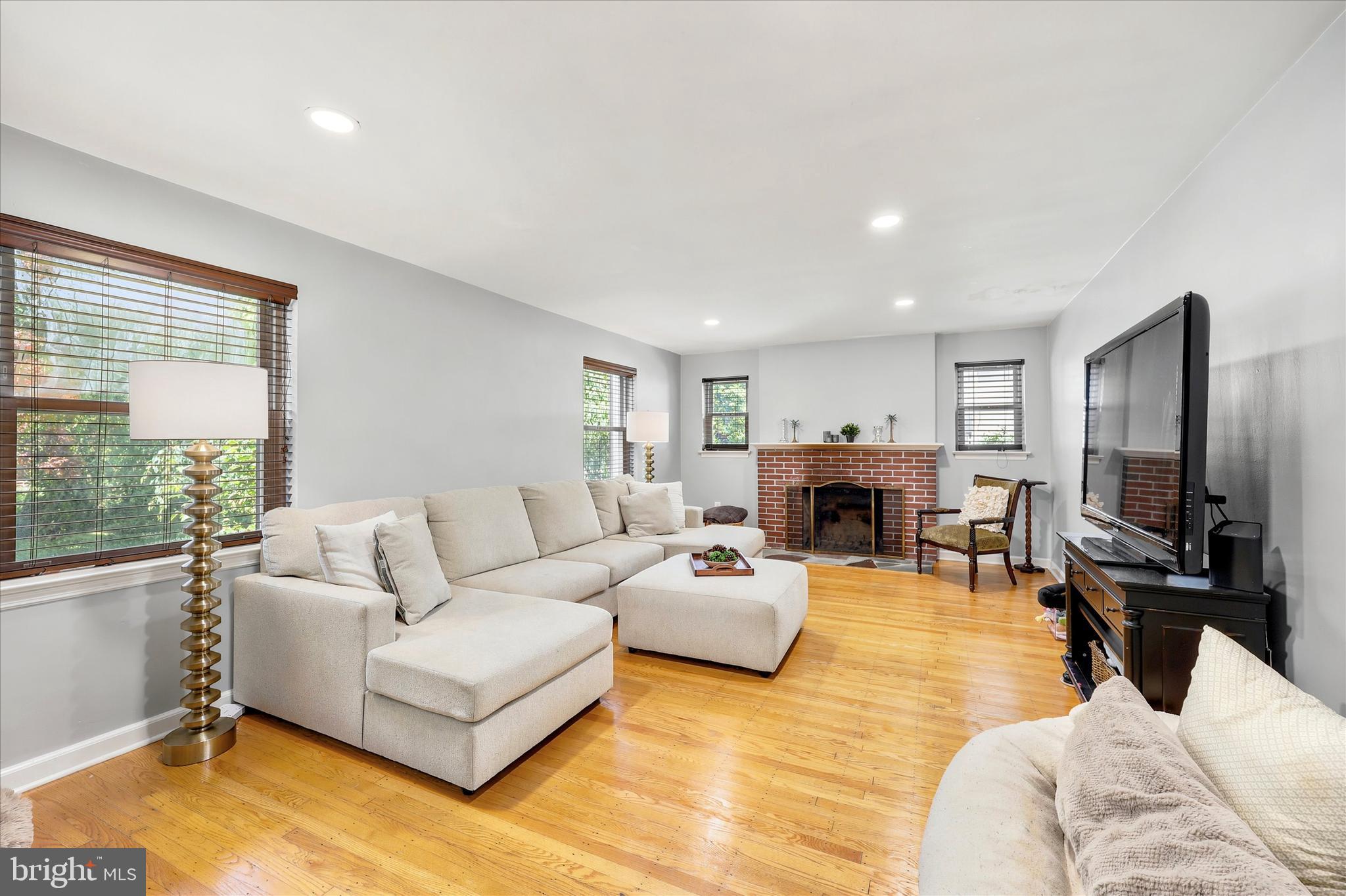 39 Haverford Road Ardmore, PA 19003 - Photo 2 of 24 a living room with furniture a fireplace and a flat screen tv