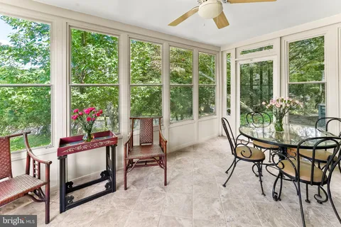 a living room with furniture a fireplace and a chandelier