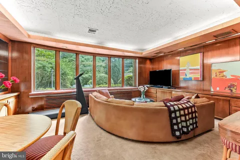 a view of a dining room with furniture wooden floor and chandelier