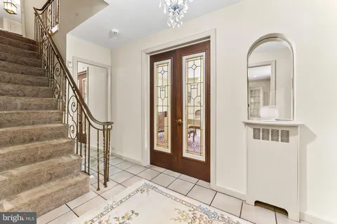 a bathroom with a toilet a sink and a large mirror