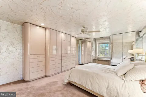 a bedroom with furniture and a large window