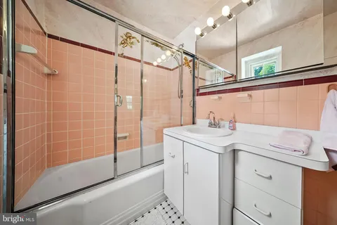 a living room with furniture and a mirror