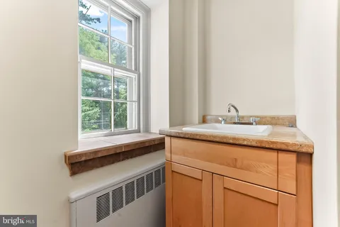 a view of a room with wooden floors