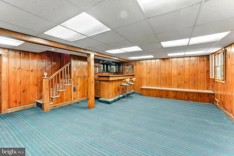 a view of a patio with a table and chairs next to a yard