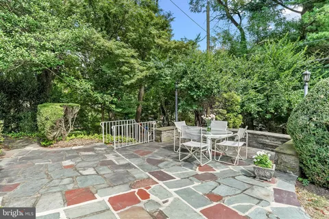 a view of a chair and tables in the patio