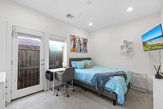 a bedroom with a bed and a desk